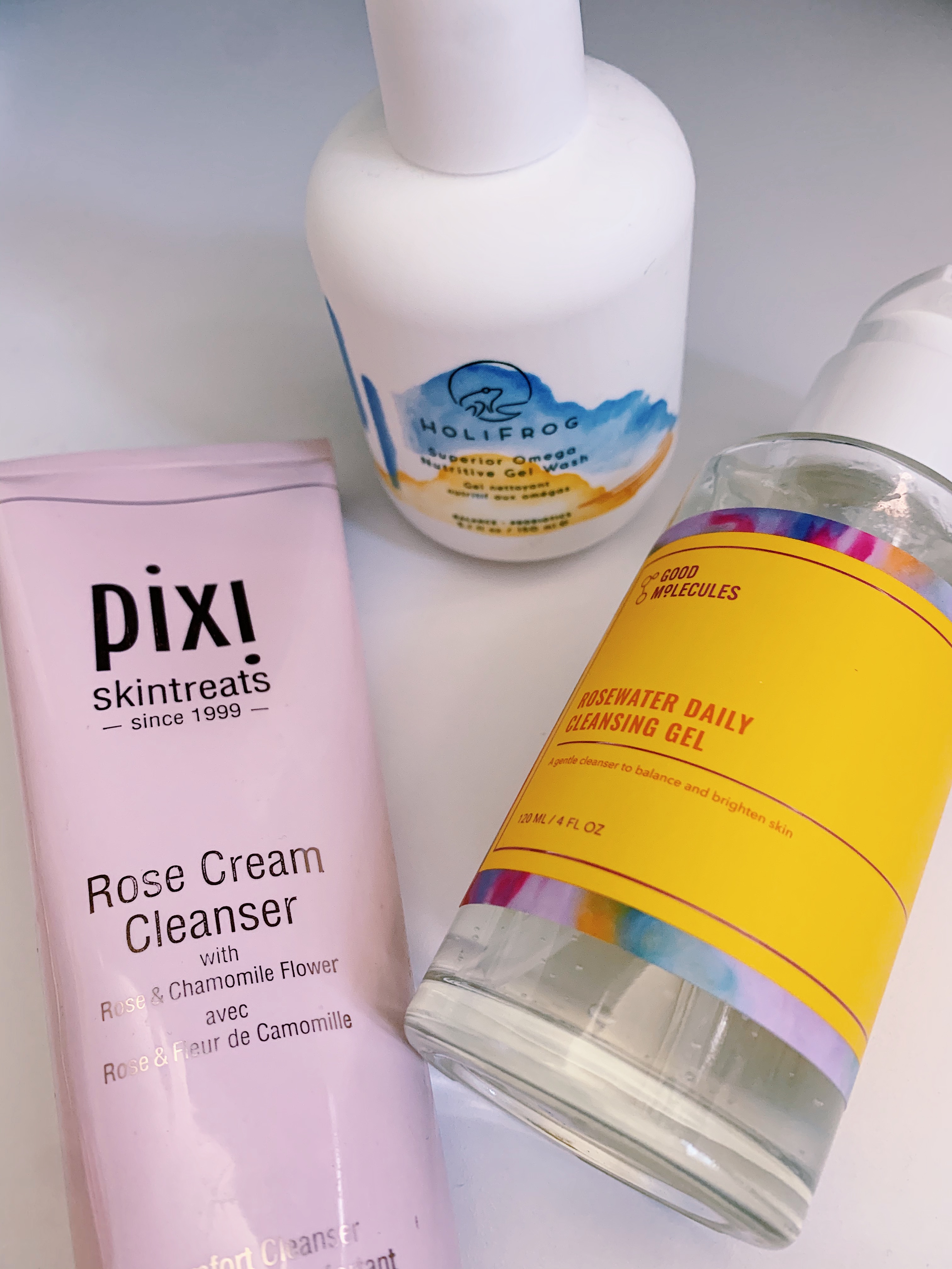 A photo of three facial cleansers that would work well in a basic skincare routine.