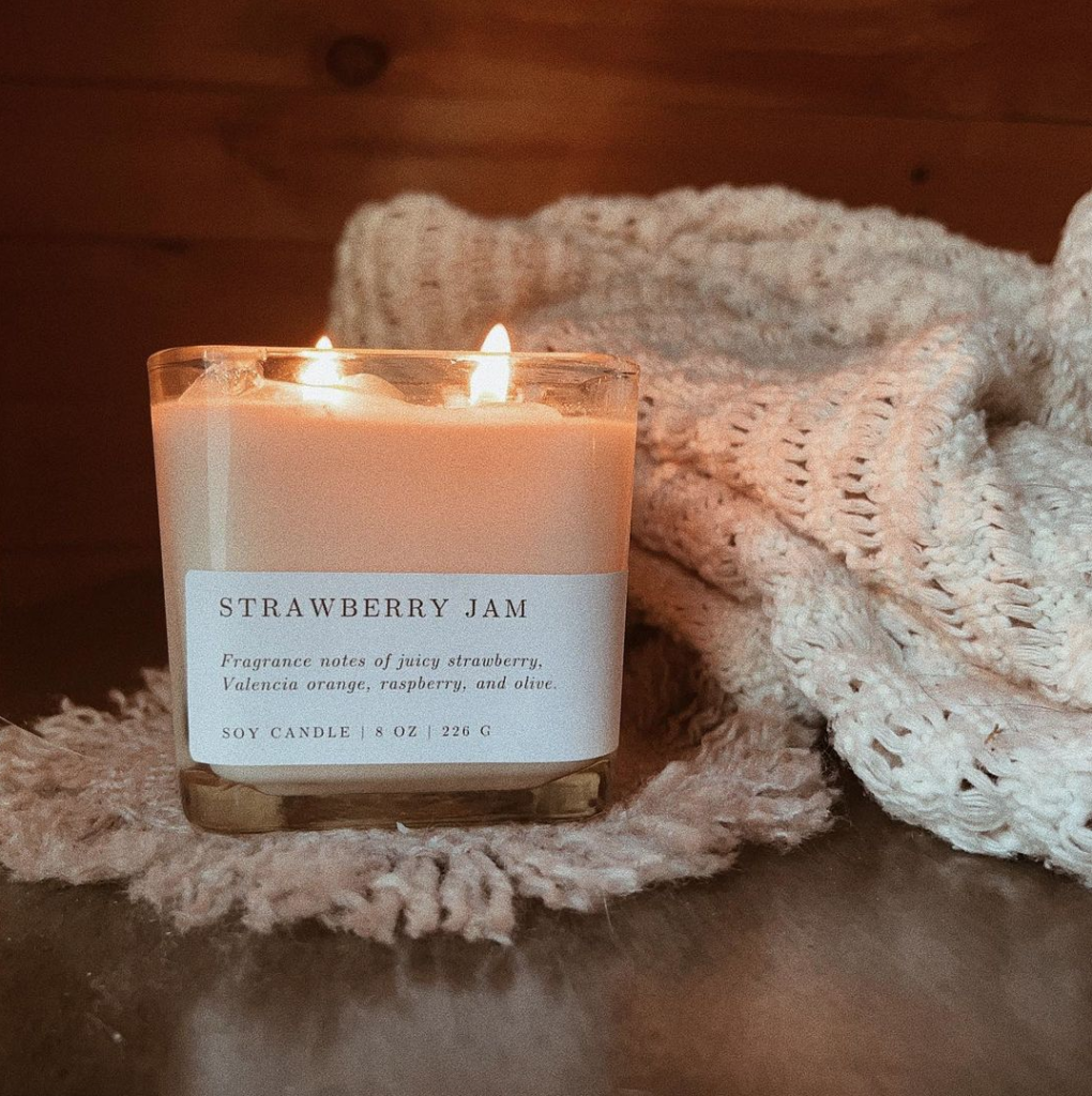 Photo of a candle from Flower & Folk, a Black-owned candle business.