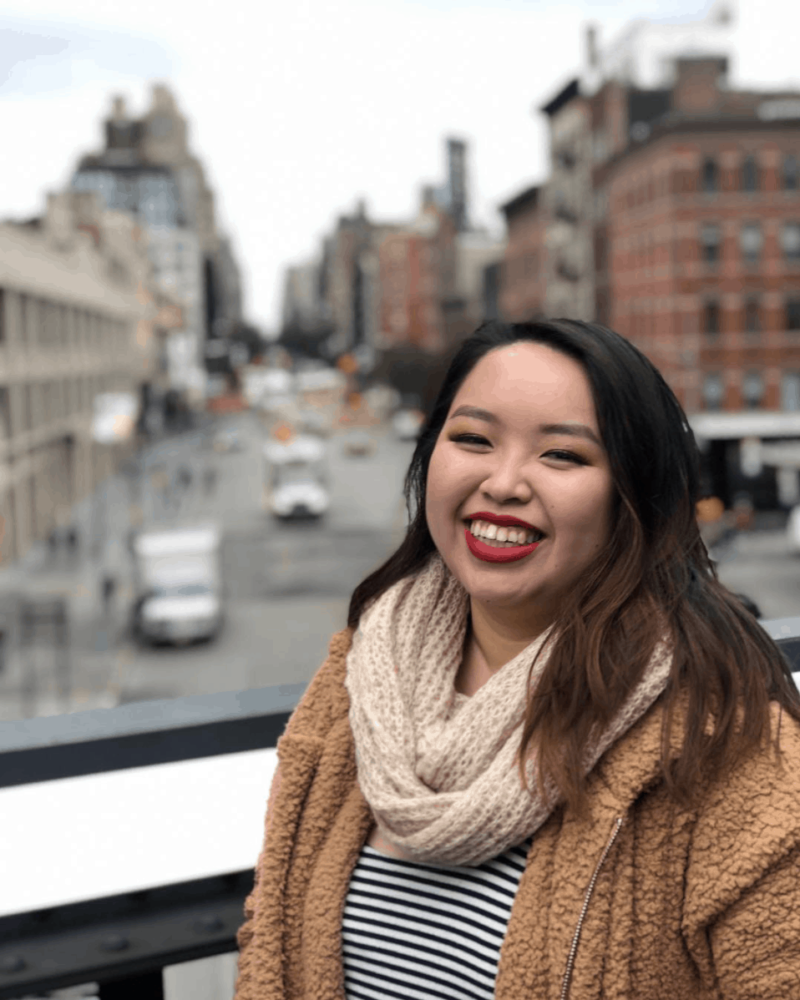 Photo of me in front of the High Line in New York on a trip for my career in beauty