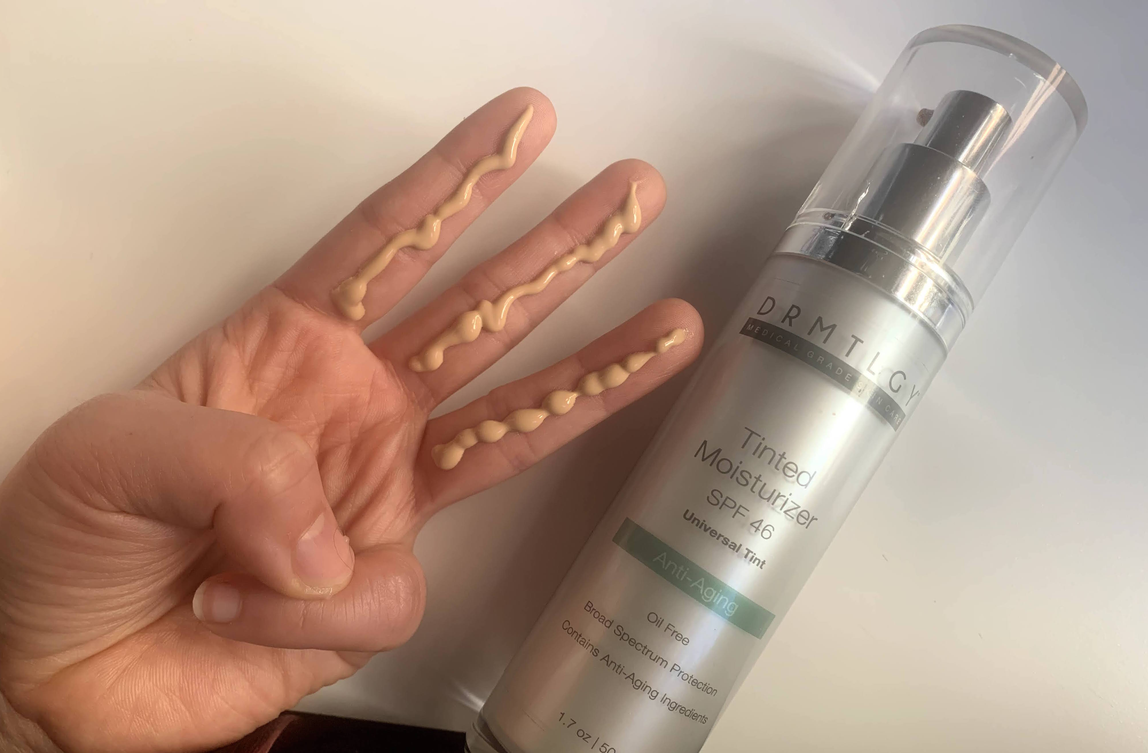 Photo showing 3 finger lengths of DRMTLGY Tinted SPF 46 Sunscreen